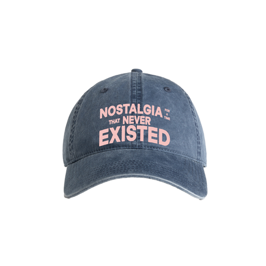 Navy cotton cap with text 'NOSTALGIA THAT NEVER EXISTED' on the front.